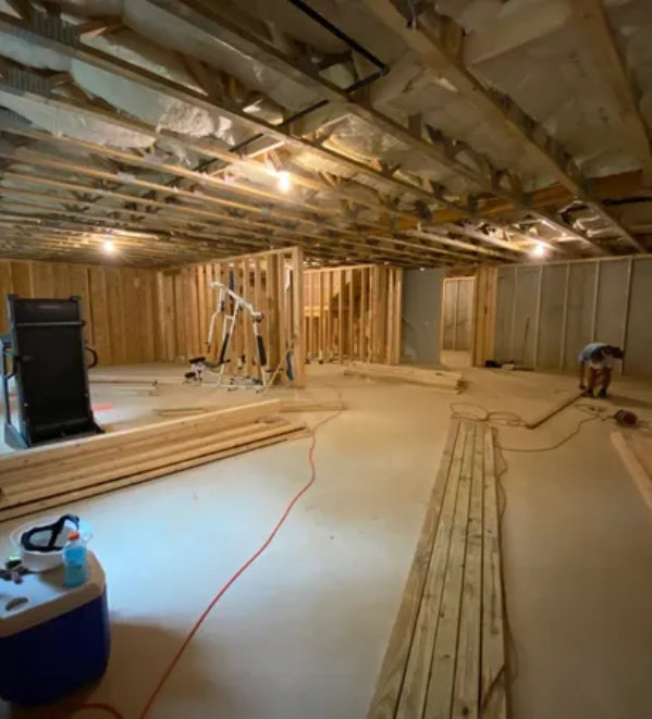 A room being remodeled with wood and other construction materials.