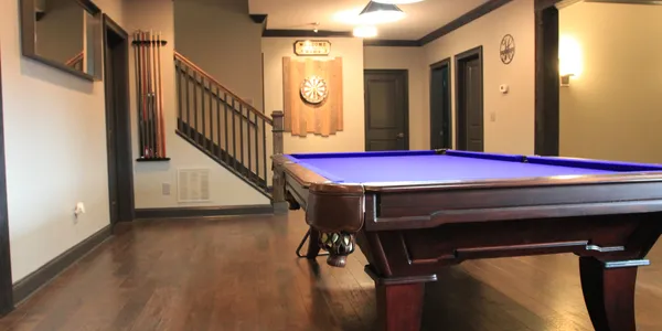 A pool table in the middle of a room.